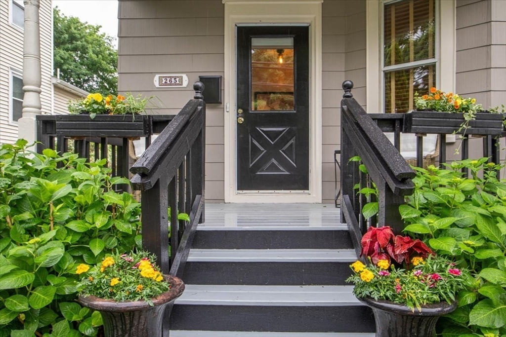 265 Sutton Street North Andover, MA 01845 - Photo 2 of 27 a front view of a house with potted plants