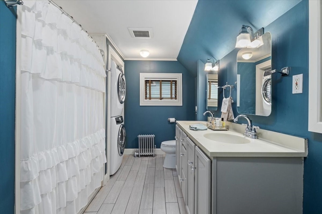 265 Sutton Street North Andover, MA 01845 - Photo 22 of 27 a bathroom with a sink a toilet a mirror and shower