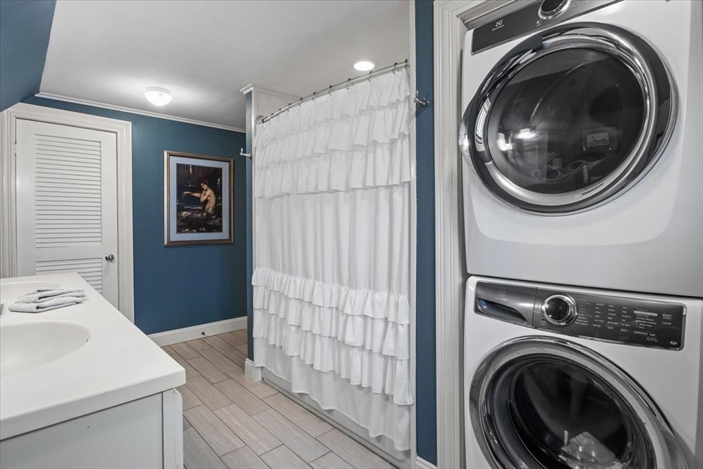 265 Sutton Street North Andover, MA 01845 - Photo 23 of 27 a view of a hallway with washer and dryer