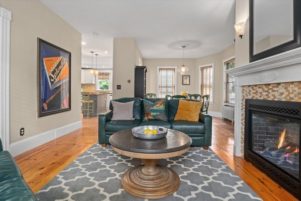 265 Sutton Street North Andover, MA 01845 - Photo 6 of 27 a living room with furniture a fireplace and a table