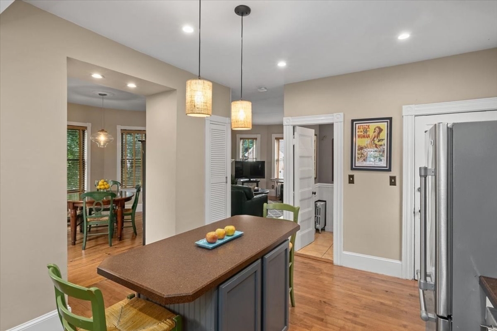 265 Sutton Street North Andover, MA 01845 - Photo 9 of 27 a open kitchen view with a refrigerator and chairs