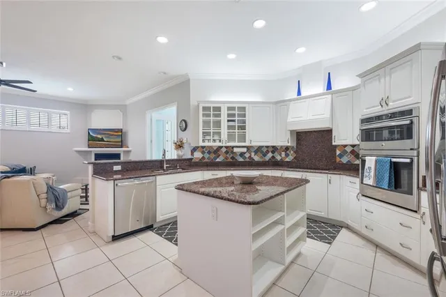 a kitchen with stainless steel appliances granite countertop a stove top oven a sink a counter top space and cabinets