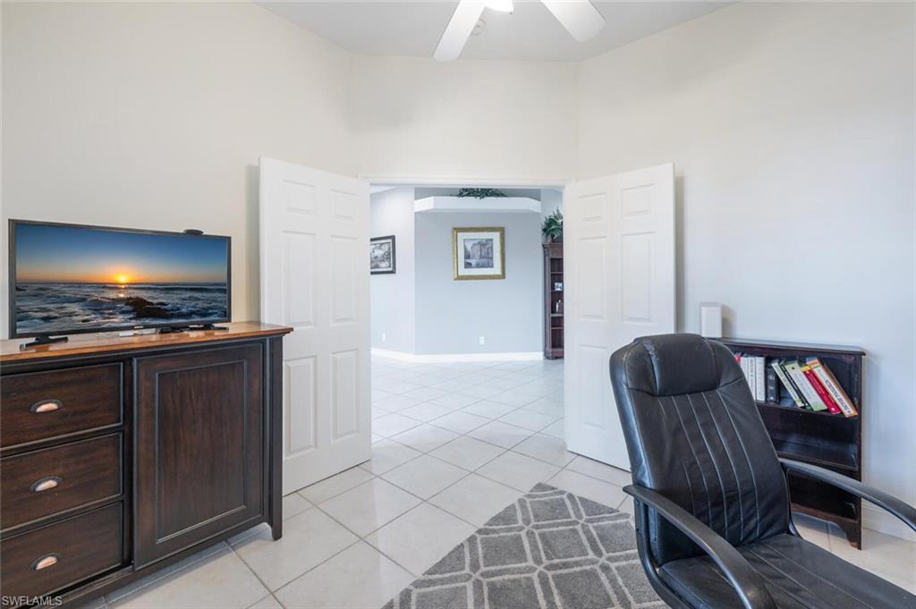 9974 Boca Avenue North Naples, FL 34109 - Photo 13 of 42 a living room with furniture and a flat screen tv