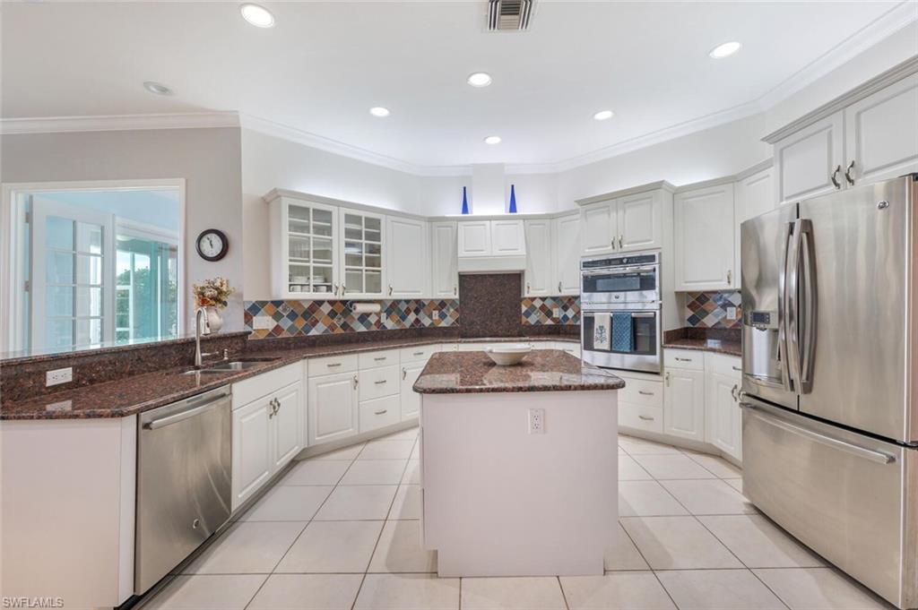 9974 Boca Avenue North Naples, FL 34109 - Photo 15 of 42 a kitchen with stainless steel appliances granite countertop a sink and a refrigerator