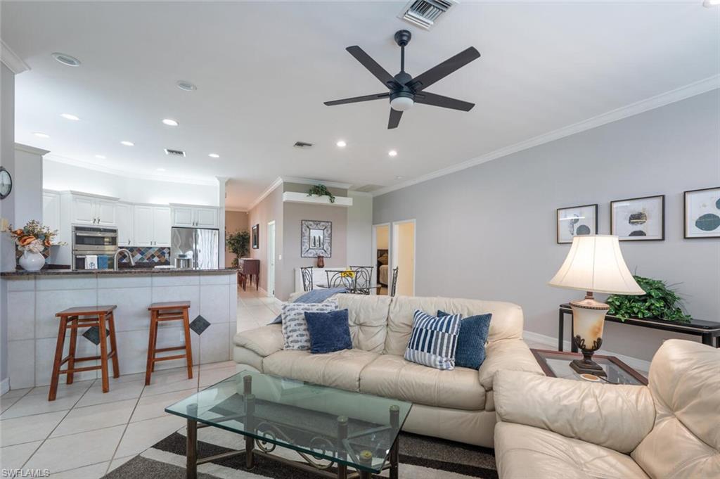 9974 Boca Avenue North Naples, FL 34109 - Photo 22 of 42 a living room with stainless steel appliances kitchen island granite countertop furniture and a view of kitchen