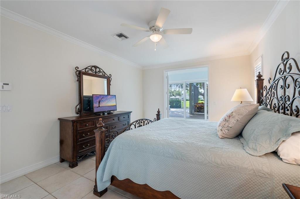 9974 Boca Avenue North Naples, FL 34109 - Photo 24 of 42 a bedroom with a bed dresser and a window