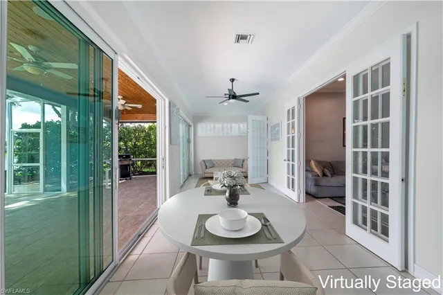 a dining room with furniture and a floor to ceiling window