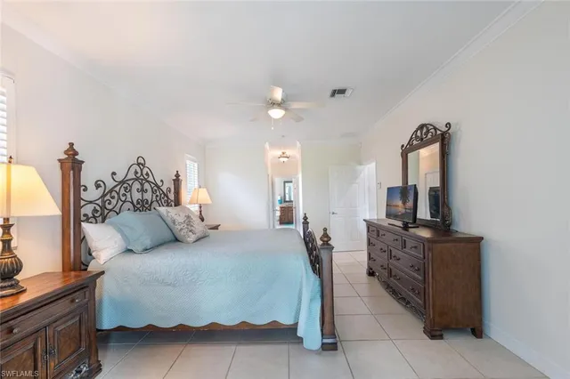 a spacious bedroom with a bed and flat screen tv