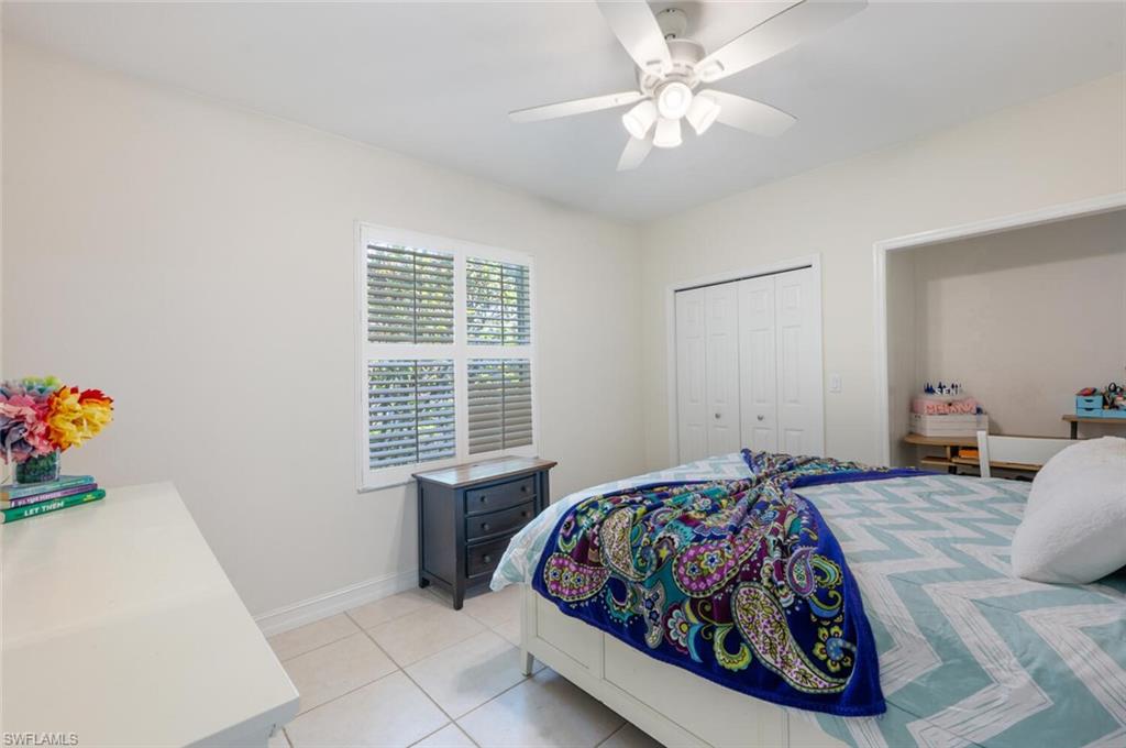 9974 Boca Avenue North Naples, FL 34109 - Photo 28 of 42 a living room with furniture and a chandelier