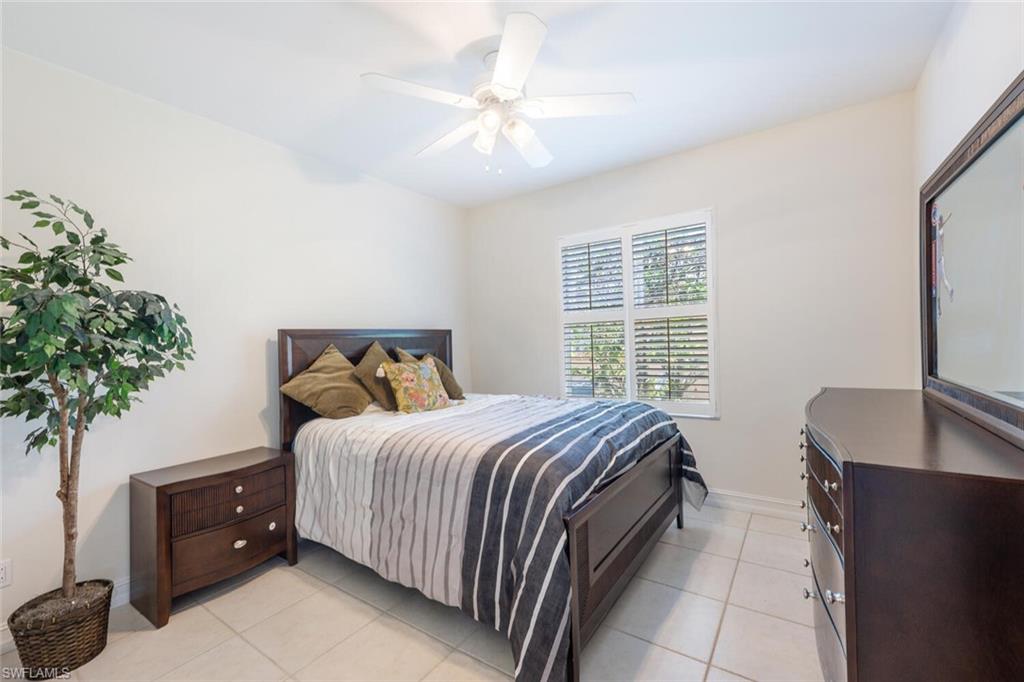 9974 Boca Avenue North Naples, FL 34109 - Photo 31 of 42 a bedroom with a bed and a potted plant