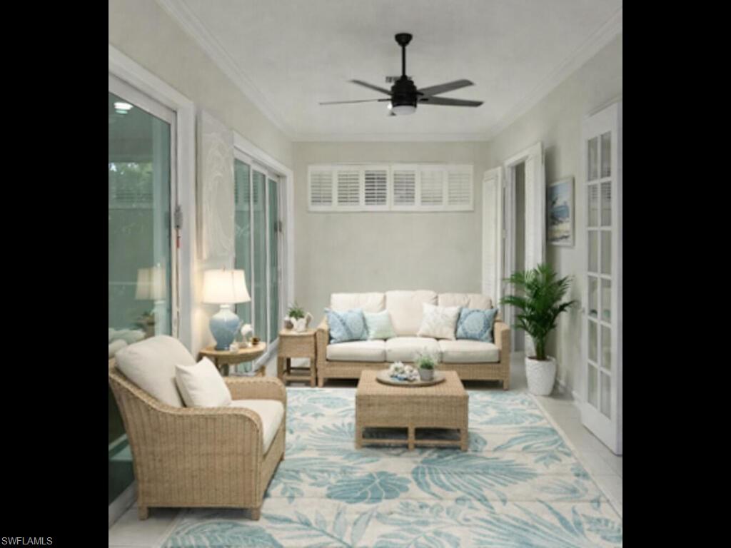 9974 Boca Avenue North Naples, FL 34109 - Photo 33 of 42 a living room with furniture and a large window