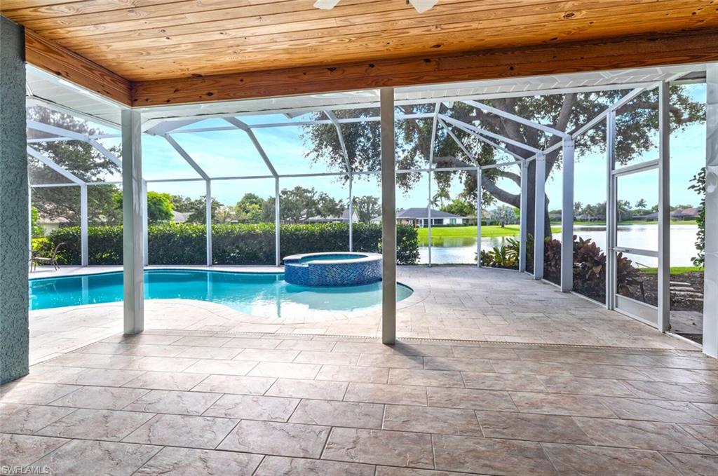 9974 Boca Avenue North Naples, FL 34109 - Photo 35 of 42 a view of a house with a backyard and a patio