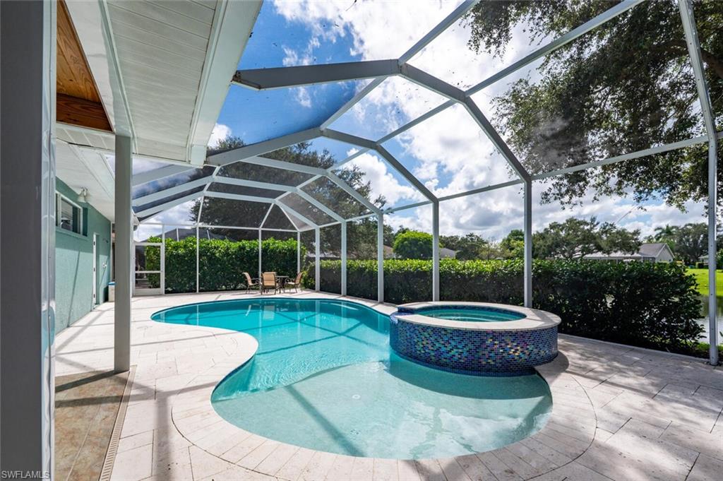 9974 Boca Avenue North Naples, FL 34109 - Photo 36 of 42 a view of a chairs and table in the patio