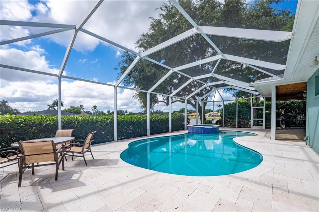 9974 Boca Avenue North Naples, FL 34109 - Photo 37 of 42 a view of a swimming pool with a patio