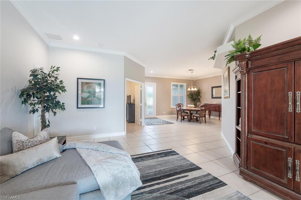 9974 Boca Avenue North Naples, FL 34109 - Photo 8 of 42 a living room with furniture and a chandelier