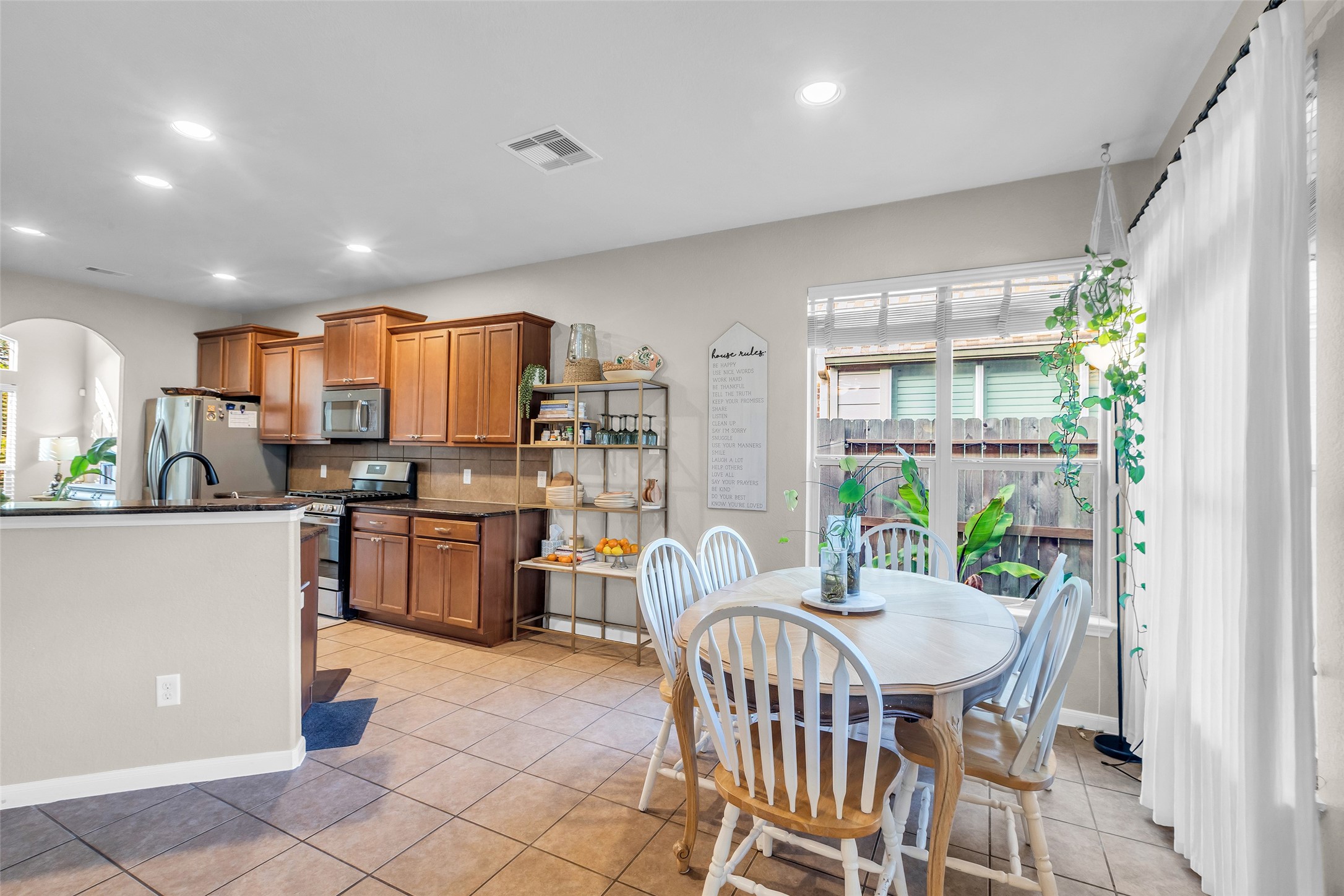155 Magnolia Grove Lane Conroe, TX 77384 - Photo 10 of 25 Bright kitchen and dining area with tile flooring.
