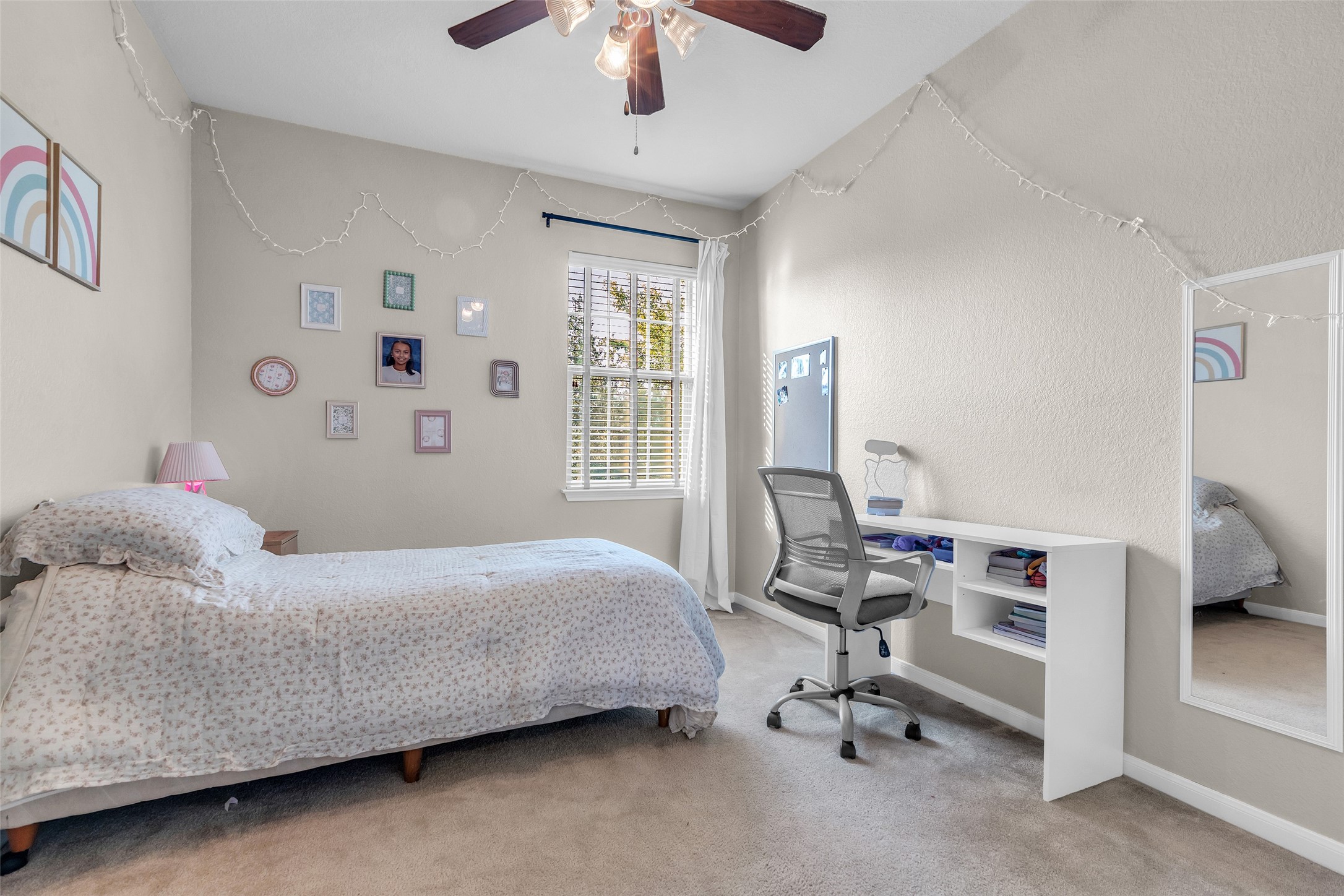 155 Magnolia Grove Lane Conroe, TX 77384 - Photo 20 of 25 4th bedroom with a large window letting in natural light. Ceiling fan provides comfort. Perfect for a child's or guest room.