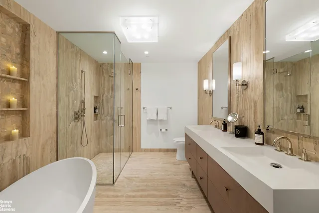 a spacious bathroom with a double vanity sink mirror double and shower