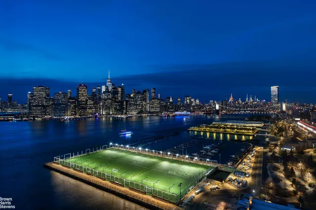a view of a swimming pool with outdoor seating