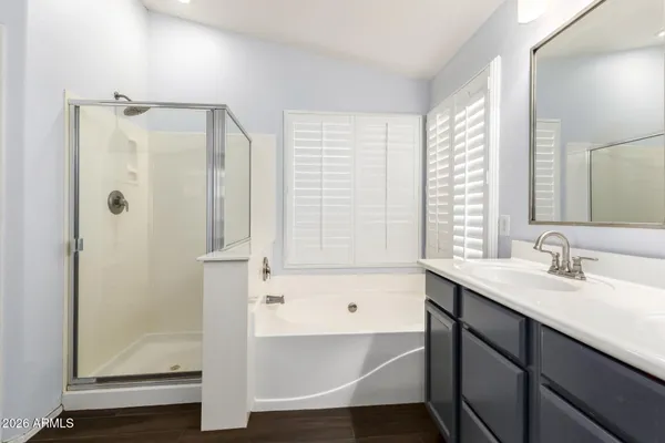 a bathroom with a tub sink and shower