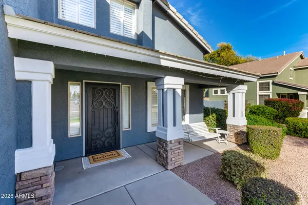 a front view of a house with outdoor seating and a potted plant