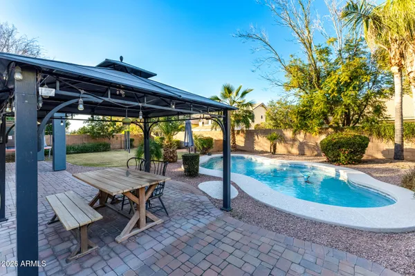 a view of a house with pool yard and sitting area