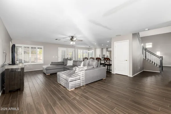 a living room with furniture and a wooden floor