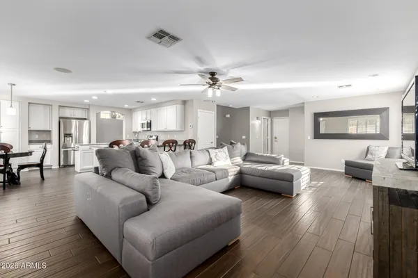 a living room with furniture and wooden floor