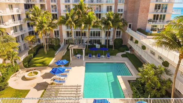 a view of an buildings with swimming pool and sitting area