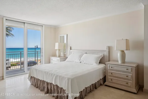 a large bed sitting in a bedroom next to a lamp
