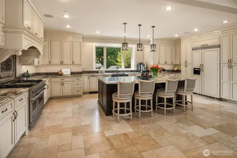 a kitchen with lots of counter top space appliances and cabinets