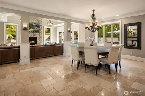 a dining room with furniture a chandelier and window