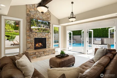 a living room with furniture a chandelier and a fireplace