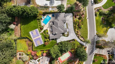 an aerial view of a house with a yard and garden