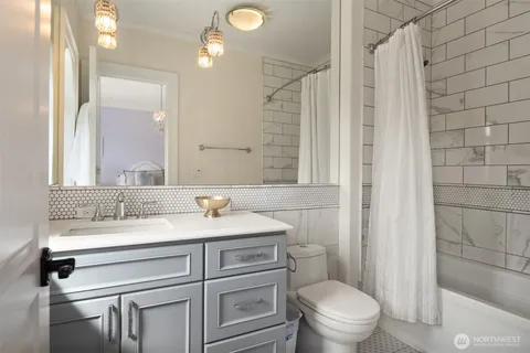 a bathroom with a sink vanity mirror and toilet