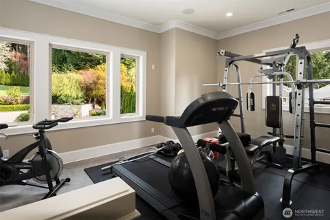 a room with gym equipment and a large window