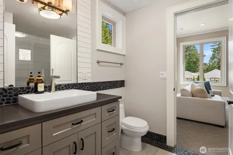 a bathroom with a toilet a sink and a mirror