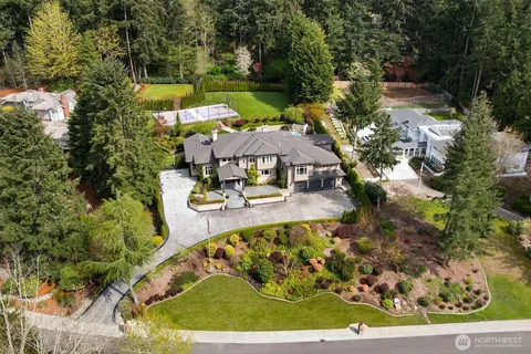 an aerial view of a house with a yard basket ball court and outdoor seating
