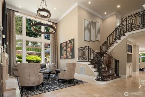 a living room with furniture chandelier and flat screen tv