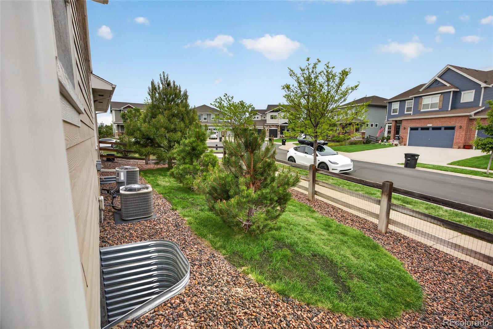 20554 East Shady Ridge Road Parker, CO 80134 - Photo 47 of 49 a view of a house with a small yard and potted plants