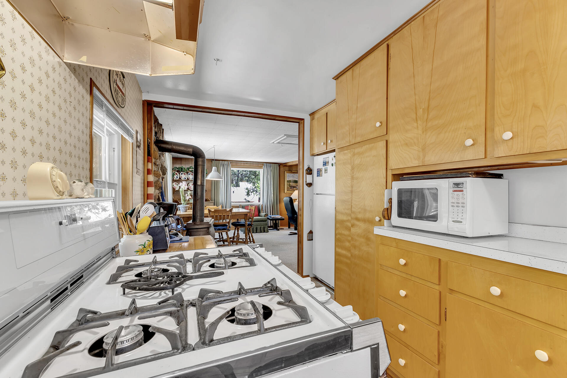 26975 Idyllwild Road Idyllwild, CA 92549 - Photo 12 of 65 a view of a kitchen with stainless steel appliances granite countertop a stove a sink dishwasher and cabinets with wooden floor