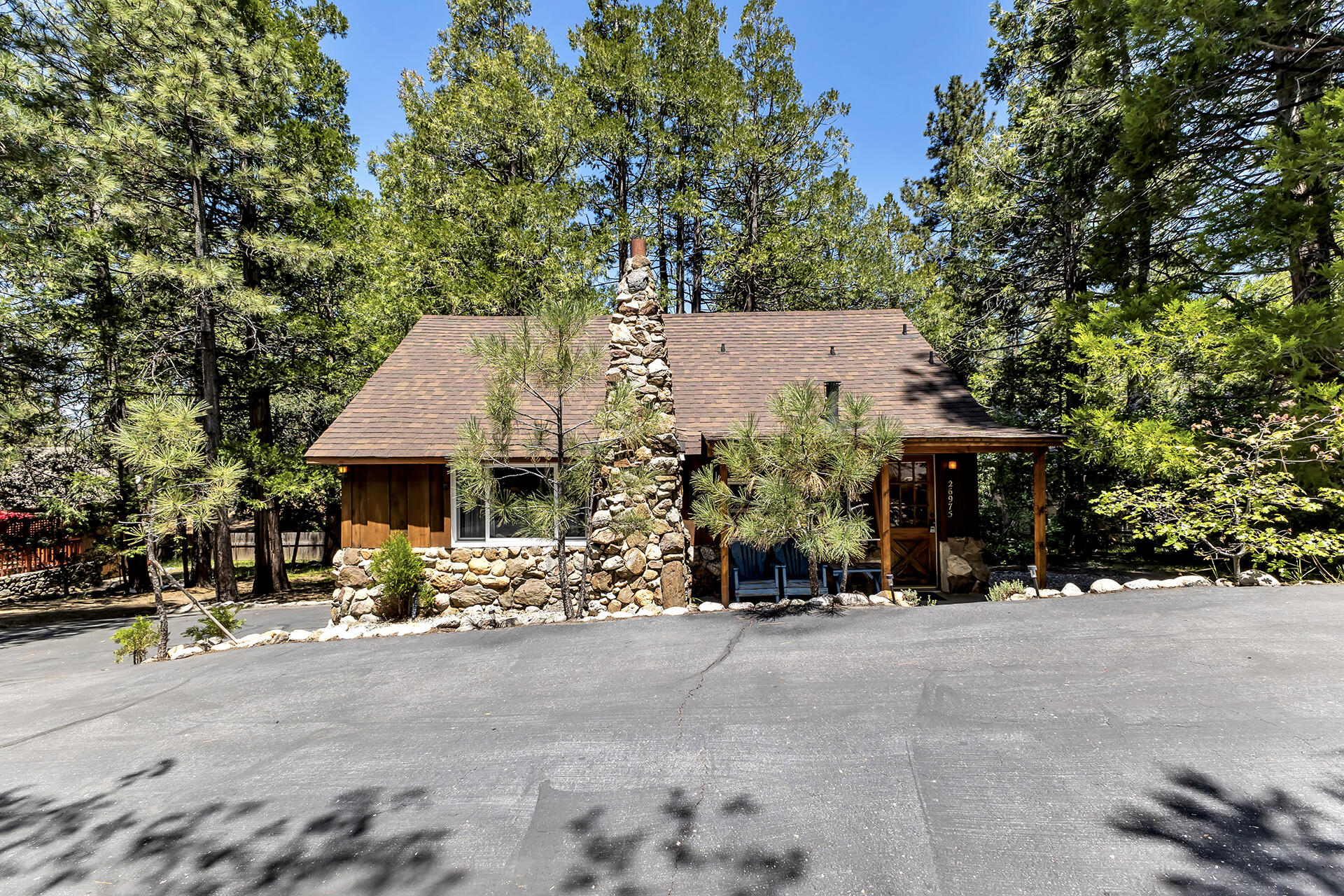 26975 Idyllwild Road Idyllwild, CA 92549 - Photo 2 of 65 a view of a patio with a table and chairs under an umbrella
