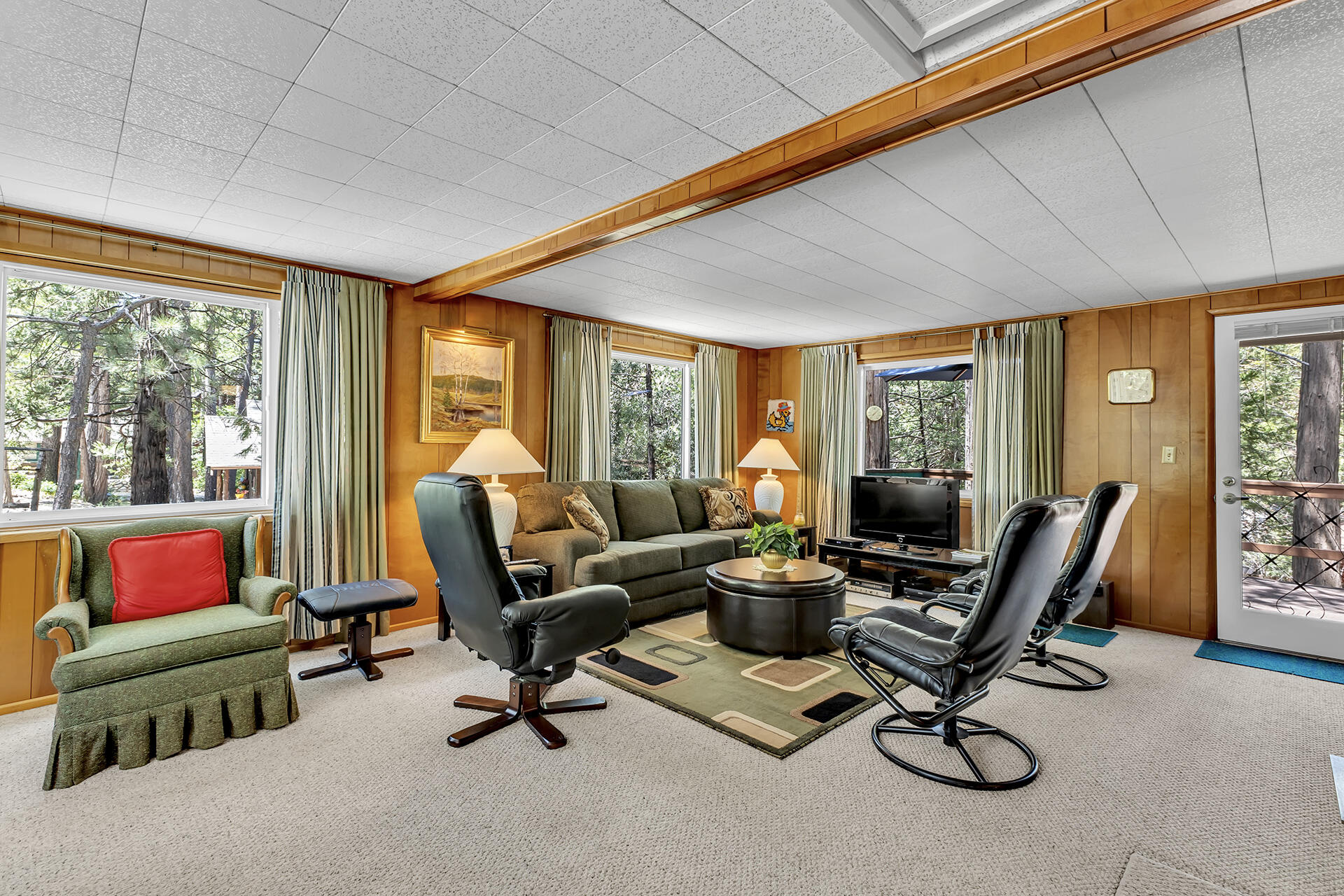 26975 Idyllwild Road Idyllwild, CA 92549 - Photo 23 of 65 a living room with furniture a flat screen tv and floor to ceiling windows