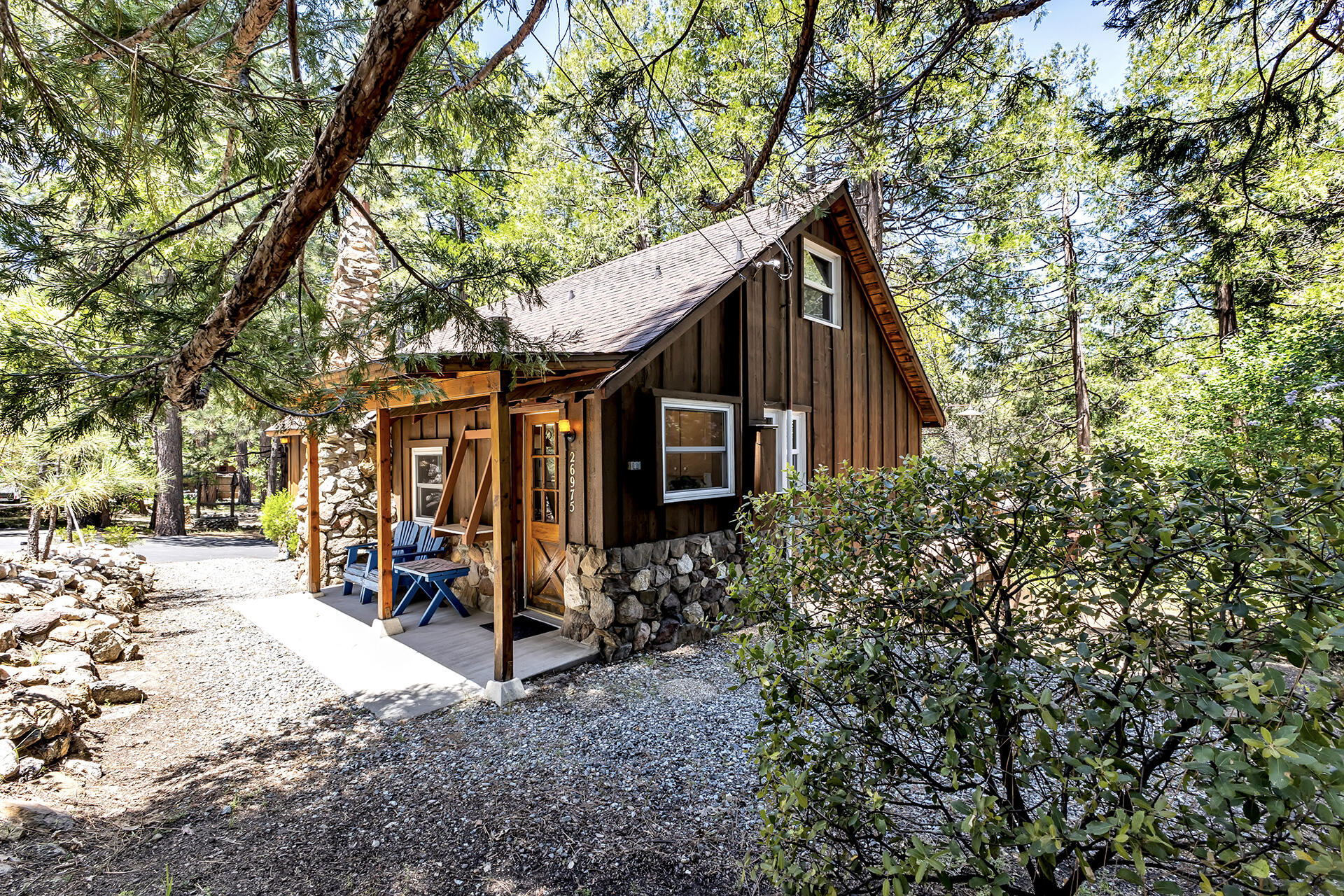26975 Idyllwild Road Idyllwild, CA 92549 - Photo 6 of 65 a view of a wooden house with large trees and playing area