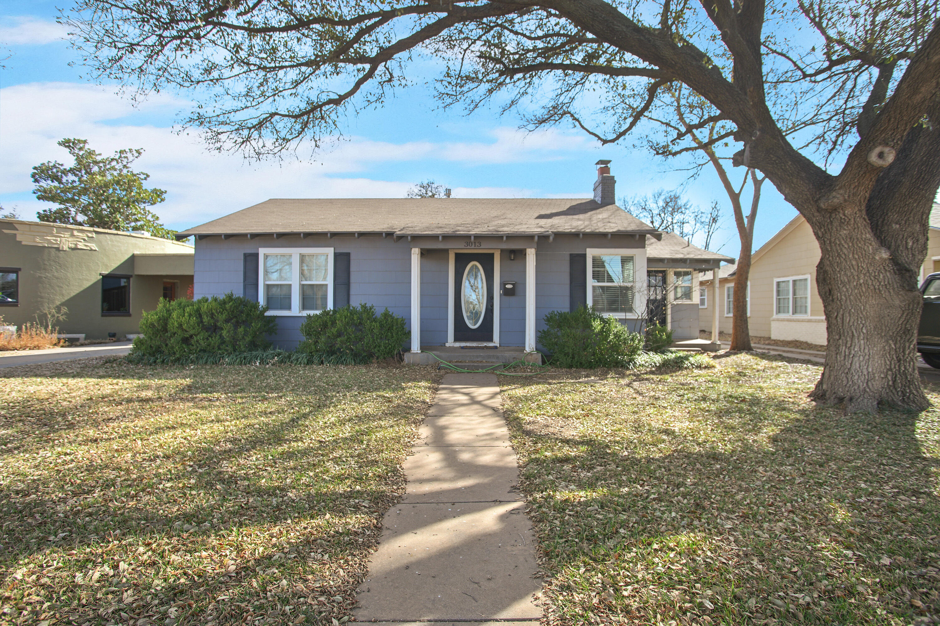 3013 28th Street Lubbock, TX 79410 - Photo 1 of 38 a view of a house with a tree in the yard