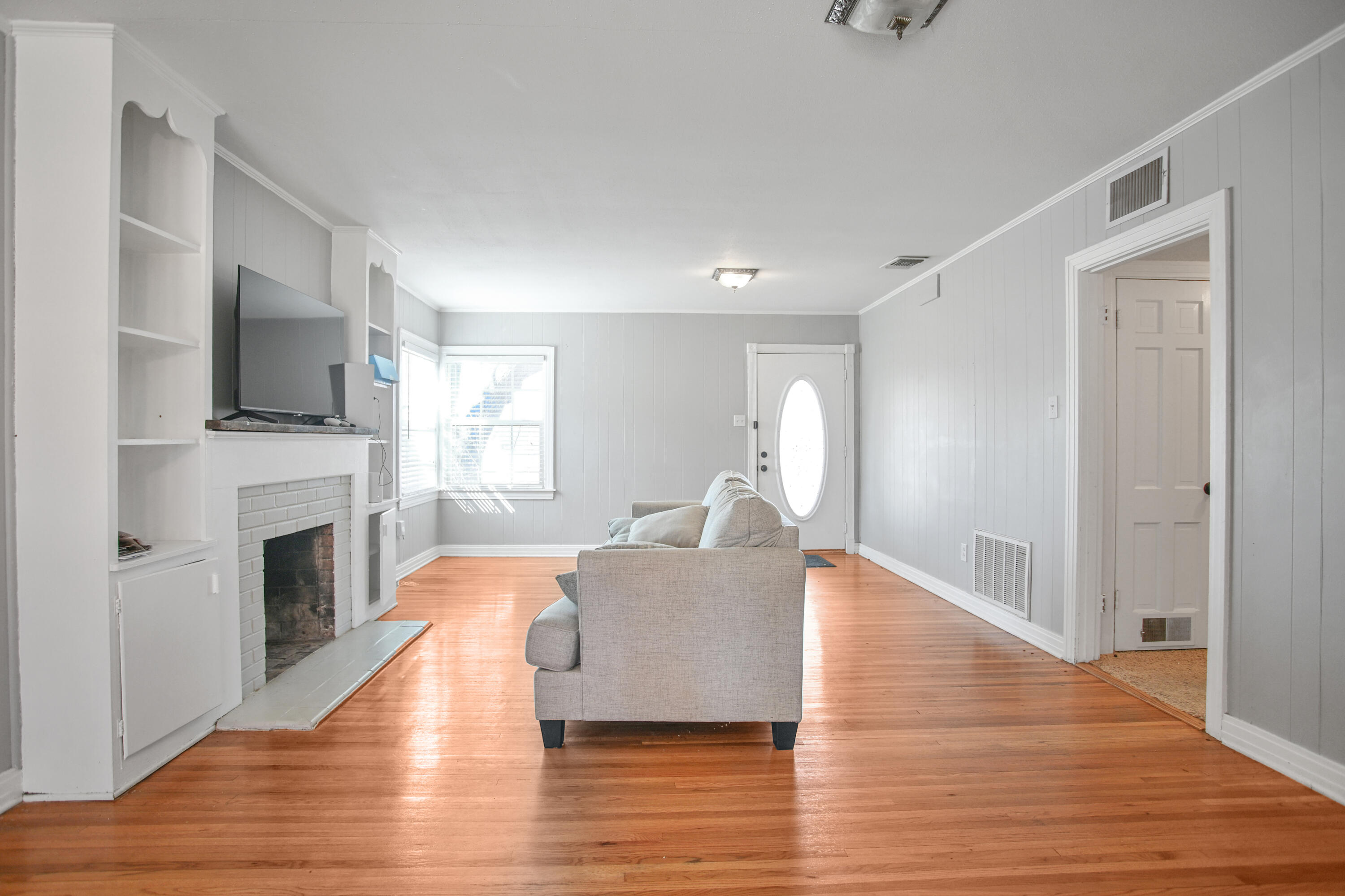 3013 28th Street Lubbock, TX 79410 - Photo 11 of 38 a living room with furniture a fireplace and a flat screen tv