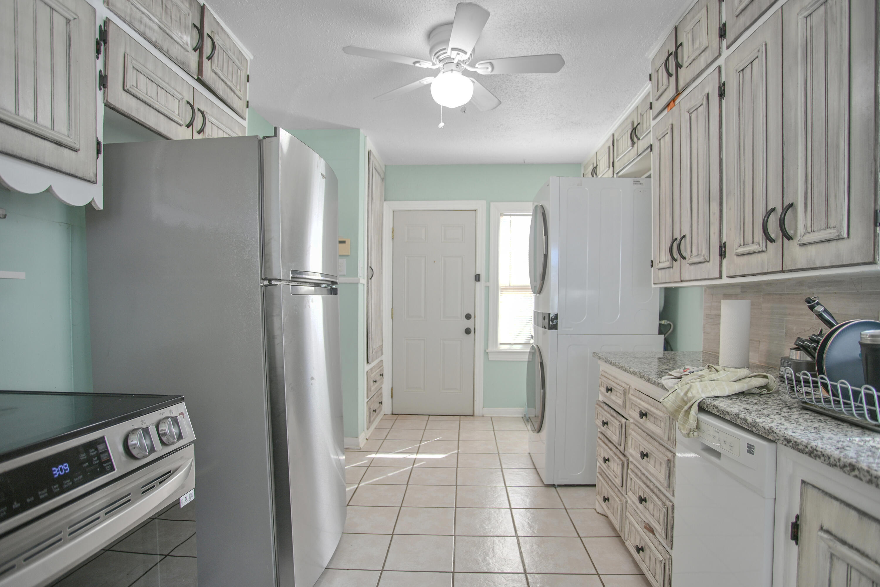 3013 28th Street Lubbock, TX 79410 - Photo 16 of 38 a kitchen with stainless steel appliances granite countertop a refrigerator and a stove top oven