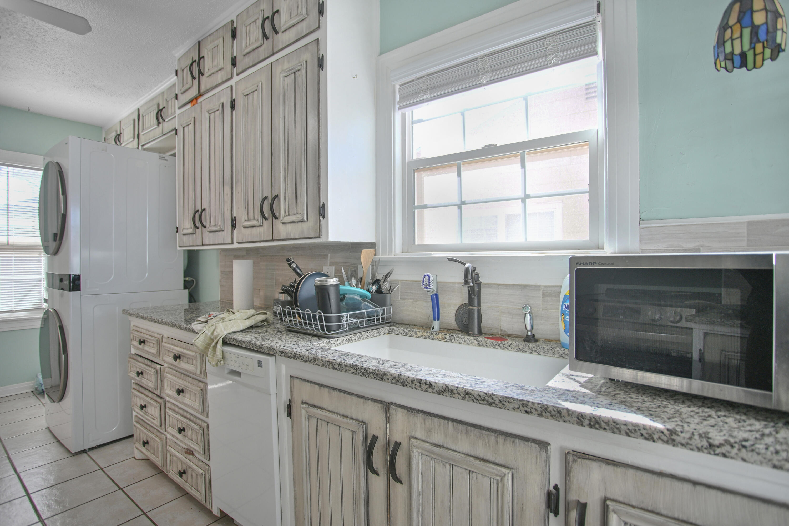 3013 28th Street Lubbock, TX 79410 - Photo 18 of 38 a kitchen with stainless steel appliances granite countertop a sink stove and cabinets