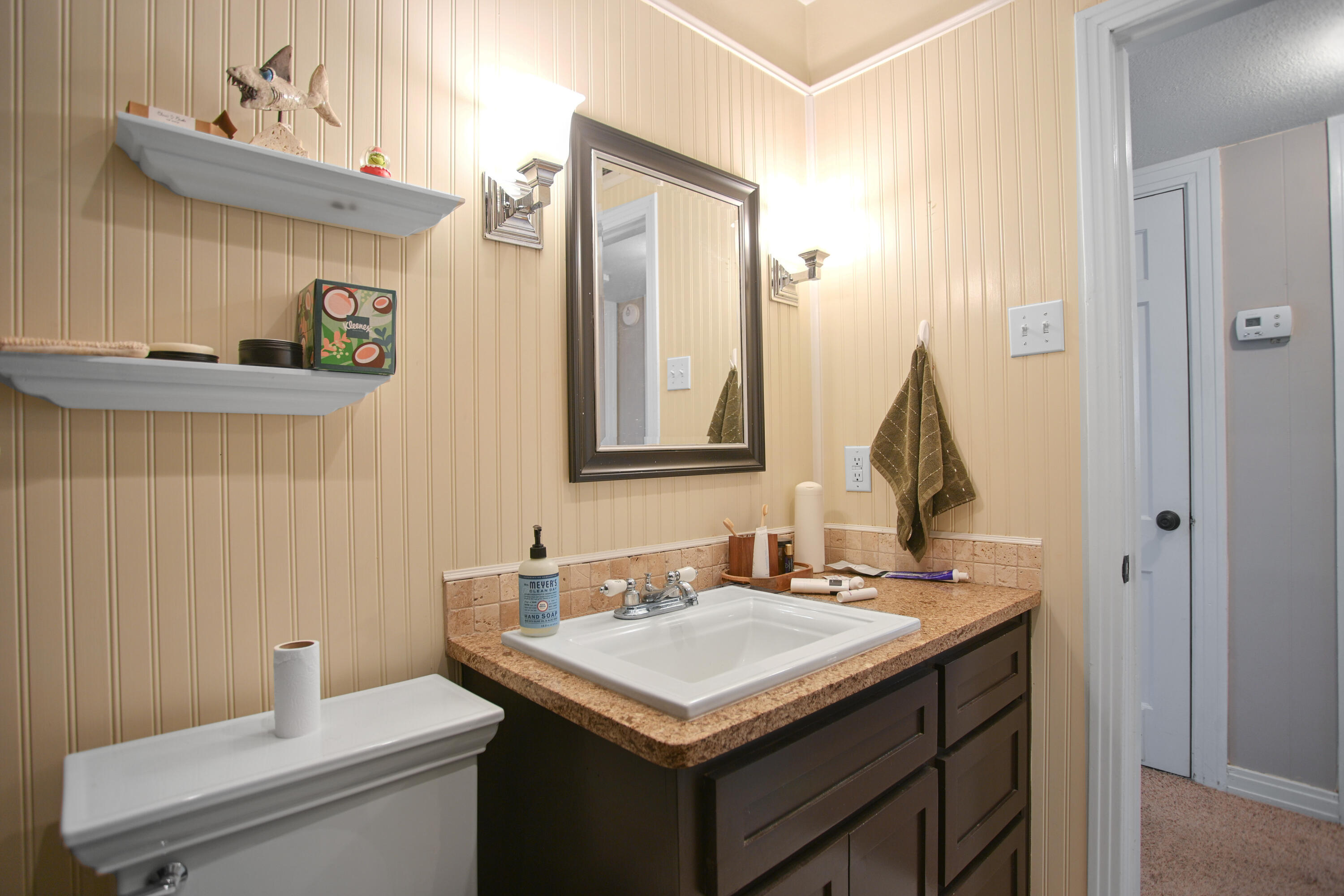 3013 28th Street Lubbock, TX 79410 - Photo 20 of 38 a bathroom with a sink and a mirror