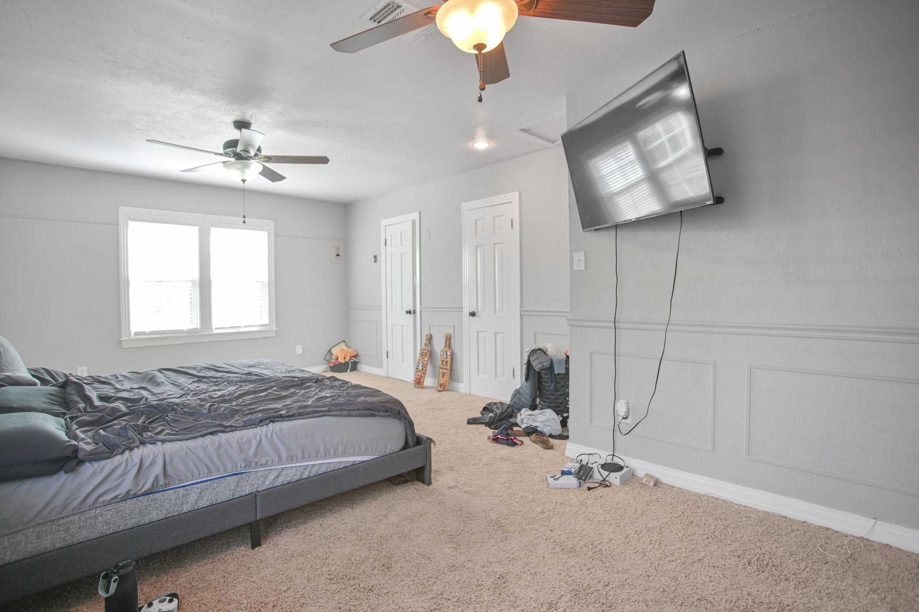 3013 28th Street Lubbock, TX 79410 - Photo 24 of 38 a bedroom with a bed and a chandelier